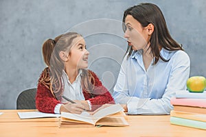 Mother who helps her daughter with the school homework