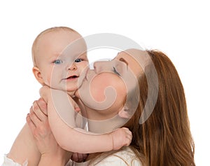Mother woman kissing in her arms infant child baby kid