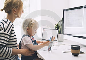 Mother working from home with little child