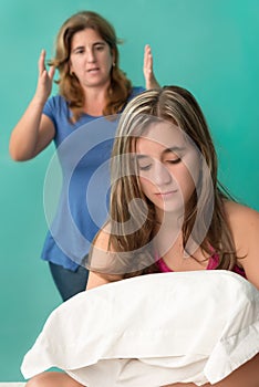 Mother yelling at her defiant teenage girl photo