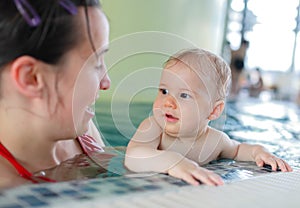 Mother with young child in pool