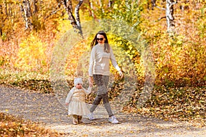 Mother and young daughter in autumn