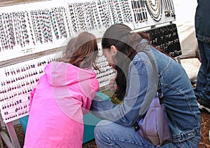 Mother and Young Daughter Selecting Jewelry at Fair