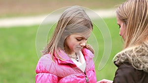 Mother zipping up daughter's jacket