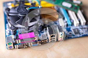The motherboard and computer components. Computer accessories on a workshop table
