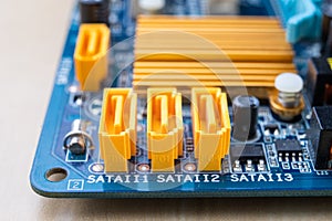 The motherboard and computer components. Computer accessories on a workshop table