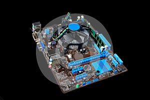 Motherboard, CPU with cooler and RAM on a black background.