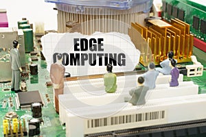 On the motherboard there are figures of people and torn paper with the inscription - Edge Computing