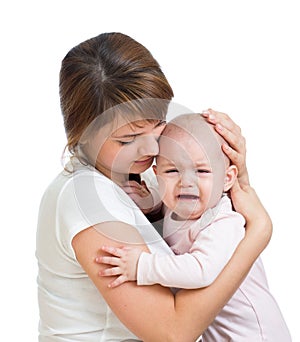 Mothercalming her crying baby isolated