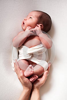 Mothercare newborn concept. Mother holding baby feet and heart