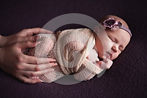 Mothercare newborn concept. Mother holding baby feet and heart