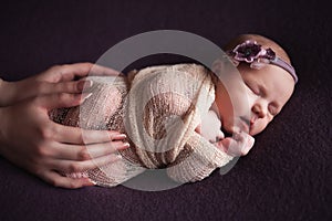Mothercare newborn concept. Mother holding baby feet and heart photo