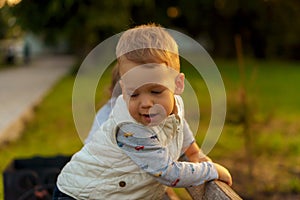 Motherhood, care, infants, summer, parenting concept - Young beautiful mom with a newborn baby in a sling walks and looks at a