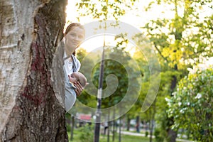 Motherhood, care, infants, summer, parenting concept - Young beautiful mom with a newborn baby in a sling walks and