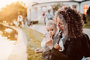 Motherhood concept - happy mom having fun with child in park