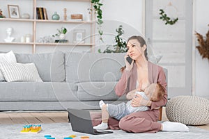 Motherhood Frustration. Bored Woman Breastfeeding Baby And Talking On Cellphone At Home