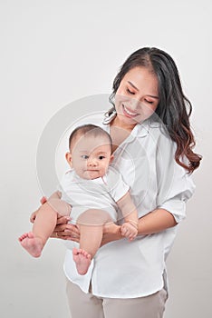 Motherhood and lifestyle concept. Smiling young mother with little baby at home