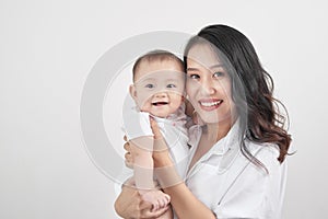 Motherhood and lifestyle concept. Smiling young mother with little baby at home