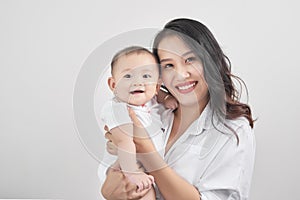 Motherhood and lifestyle concept. Smiling young mother with little baby at home