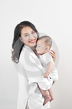 Motherhood and lifestyle concept. Smiling young mother with little baby at home