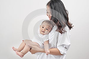 Motherhood and lifestyle concept. Smiling young mother with little baby at home