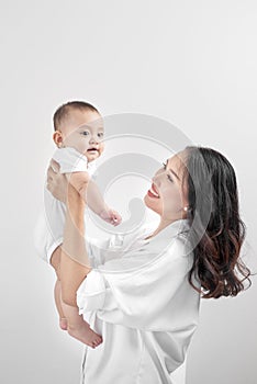 Motherhood and lifestyle concept. Smiling young mother with little baby at home