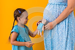 Motherhood, love, Childhood, pregnancy, hot summer - croped portrait pregnant unrecognizable mother woman blue dress