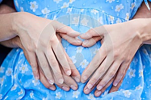 motherhood and pregnancy. hands on pregnant woman belly