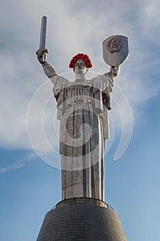 Motherland Monument decorated with red poppy flower wreath on Victory Day. Kiev