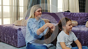 Motherly love care mom braiding hair family bond