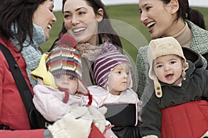 Mothers With Babies In Slings At Park