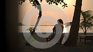 Mothers of a carrying child on a sunbed on the beach