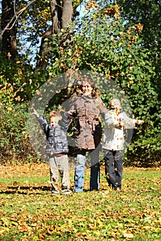 Mothers and children in autumn park.