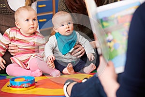 Mothers With Children At Baby Group Listening To Story photo