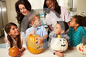 Mothers And Children Making Halloween Lanterns