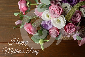 Mothers day card. Bouquet of pink roses in basket on wooden background closeup