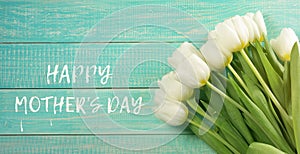 Mothers day card. White tulips on wooden turquoise background
