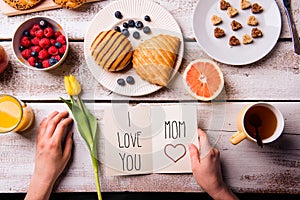 Mothers day composition. Greeting card and breakfast meal.