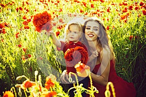 Mothers day, girl and little boy in field of poppy