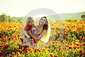 Mothers day, girl and little boy in field of poppy