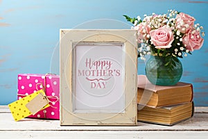 Mothers day greeting card with rose flower bouquet, gift box and photo frame