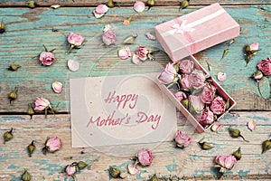 Mothers Day greeting message with little pink roses in a box on