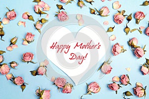 Mothers Day greeting message with small pink roses on blue background.