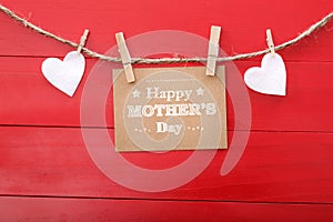 Mothers day message with felt hearts hanging with clothespins