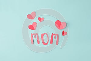 Mothers day message on paper cut hearts over blue background, simple diy creative idea, banner, greeting card for mom