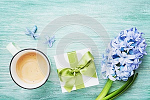 Mothers Day spring greeting background with flowers, gift or present box and cup of coffee top view. Morning breakfast for holiday