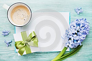 Mothers Day spring holiday card with empty notebook for greeting text with cup of coffee, gift or present box and hyacinth flowers