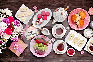 Mothers Day tea table scene against a dark wood background