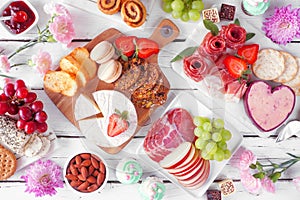 Mothers Day theme charcuterie table scene against a white wood background