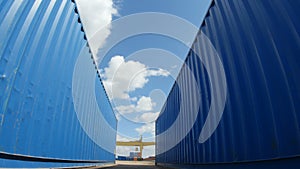 Motion between Blue Big Containers in Blue Sky Background